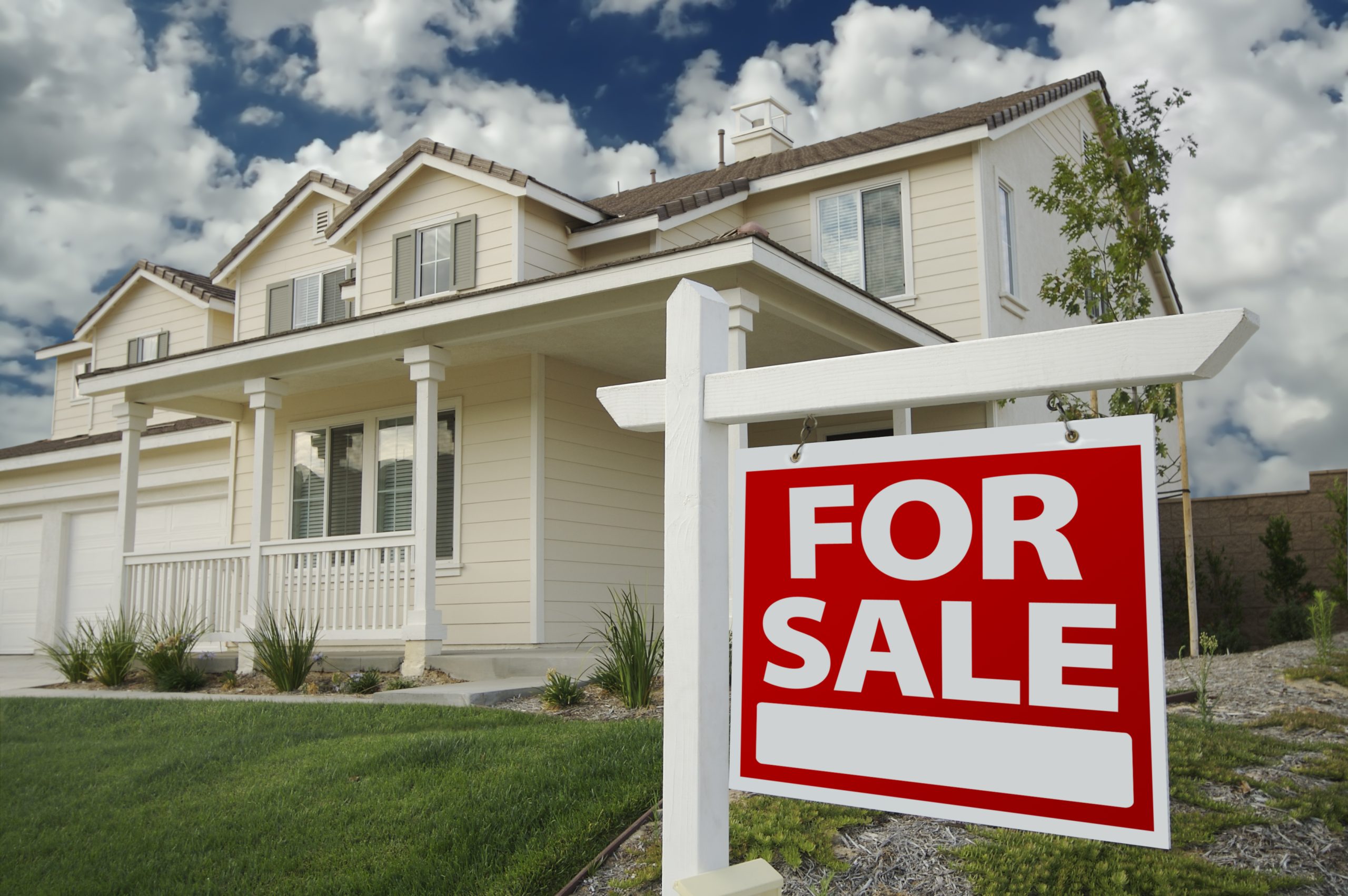 Home For Sale Real Estate Sign in Front of New House.