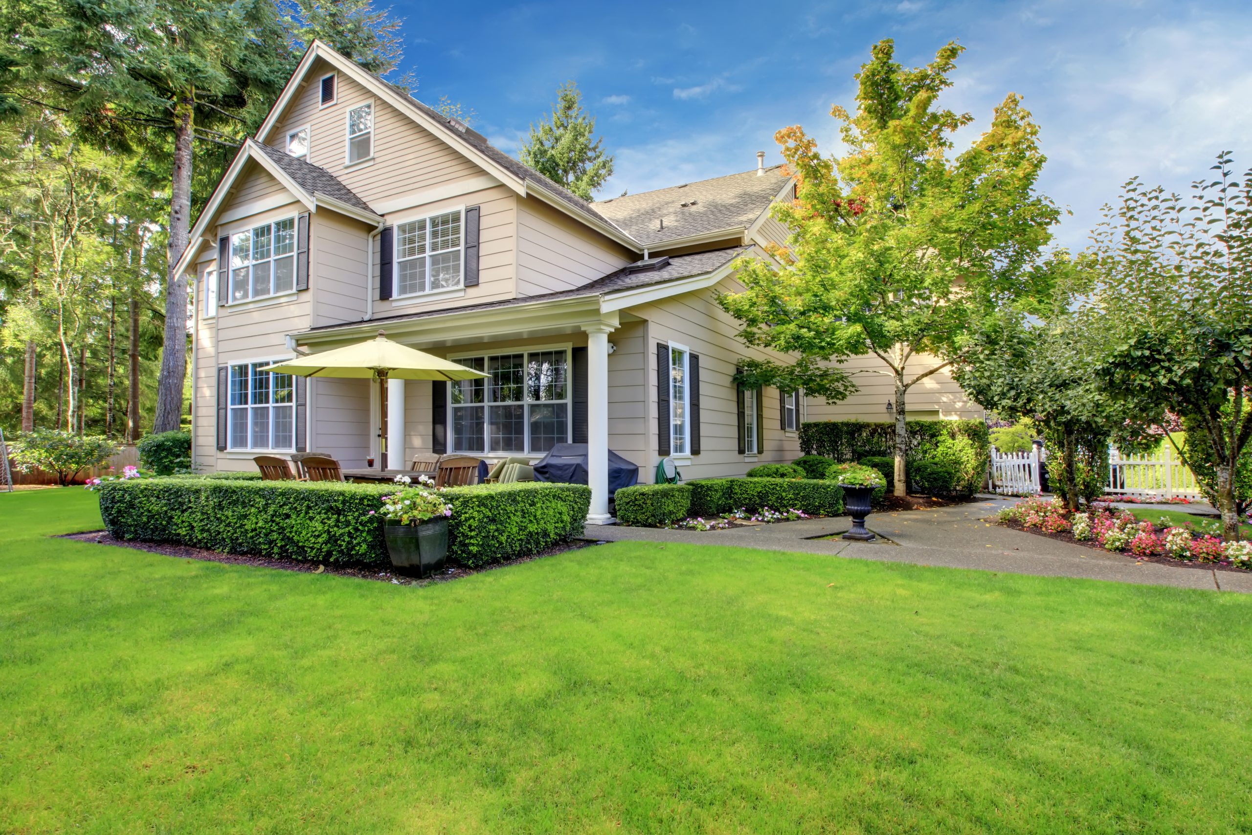 Large beige house with green grass